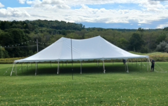 A large white tent under a blue sky